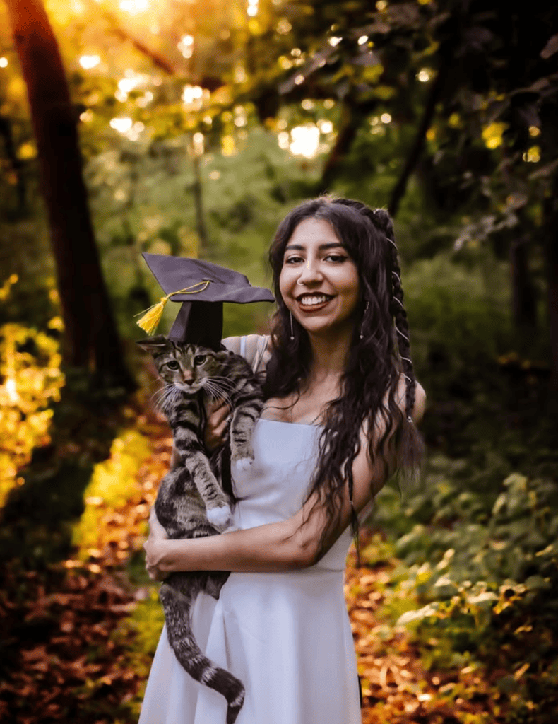 Senior girl posing with her cat during a senior portrait session