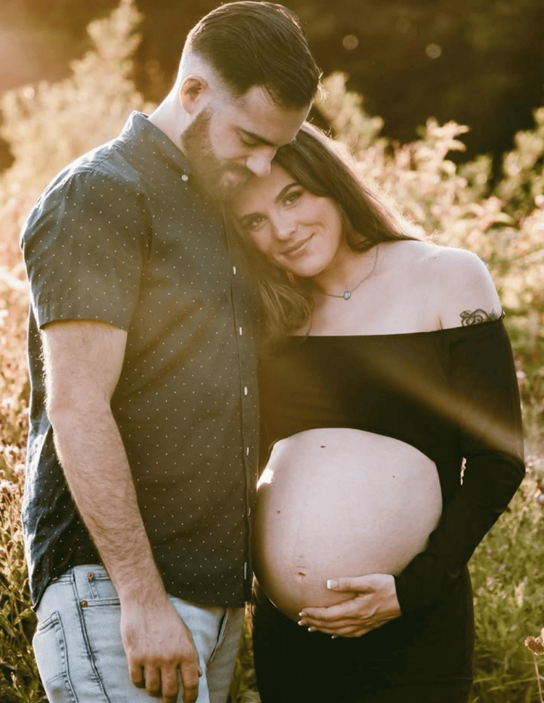 Couple maternity photoshoot in a fall field