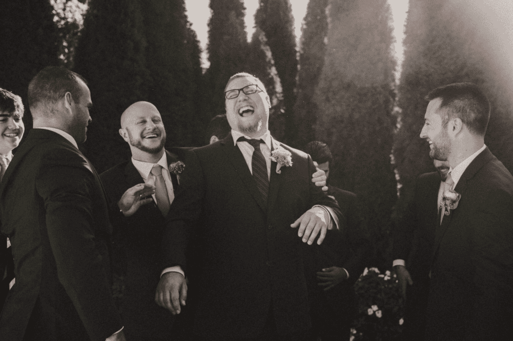 post wedding ceremony celebration between groom and groomsmen