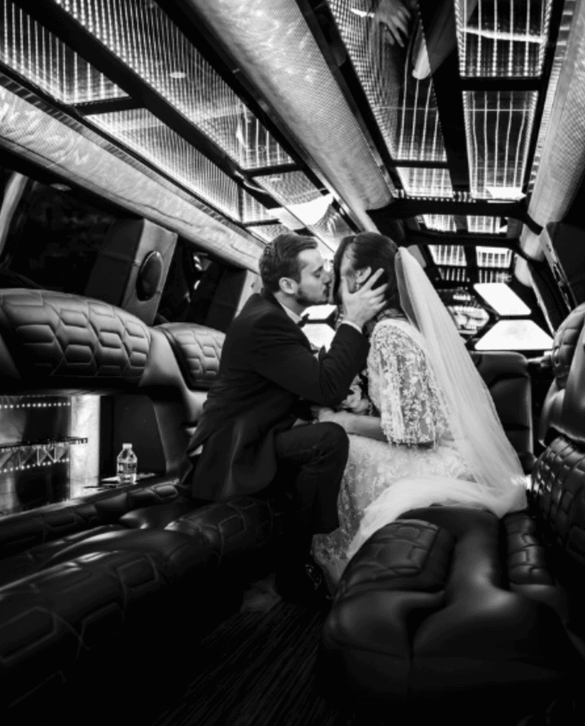 Bride and groom in limo after wedding reception