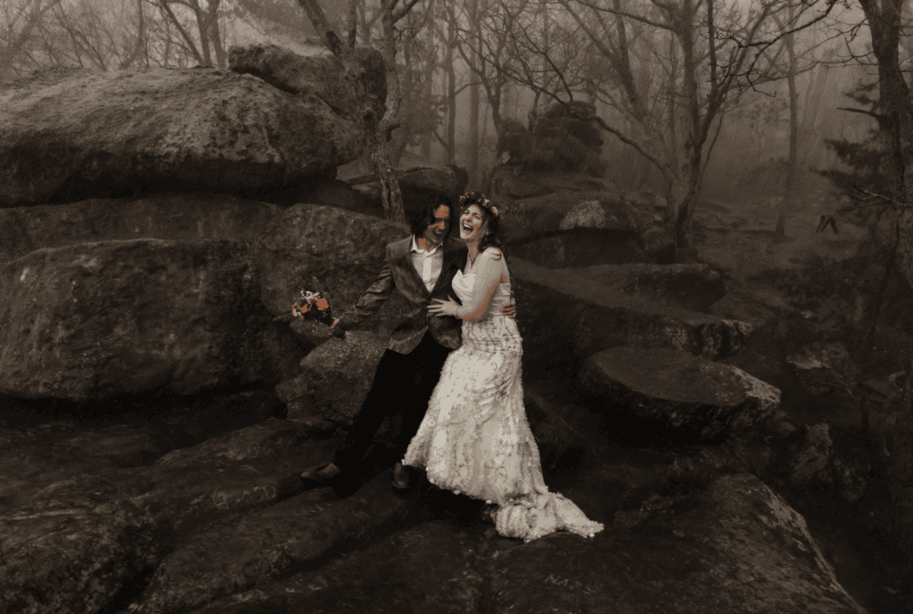 bride and groom outside laughing together during wedding portraits