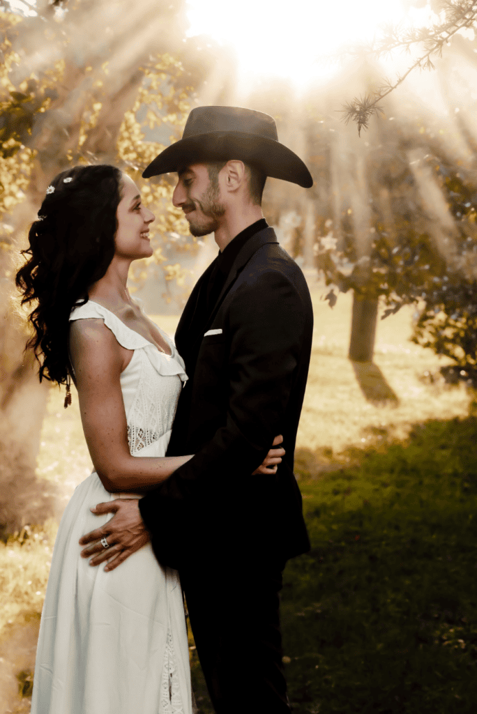 Bride and groom standing together in a field during their Maryland wedding portrait session.