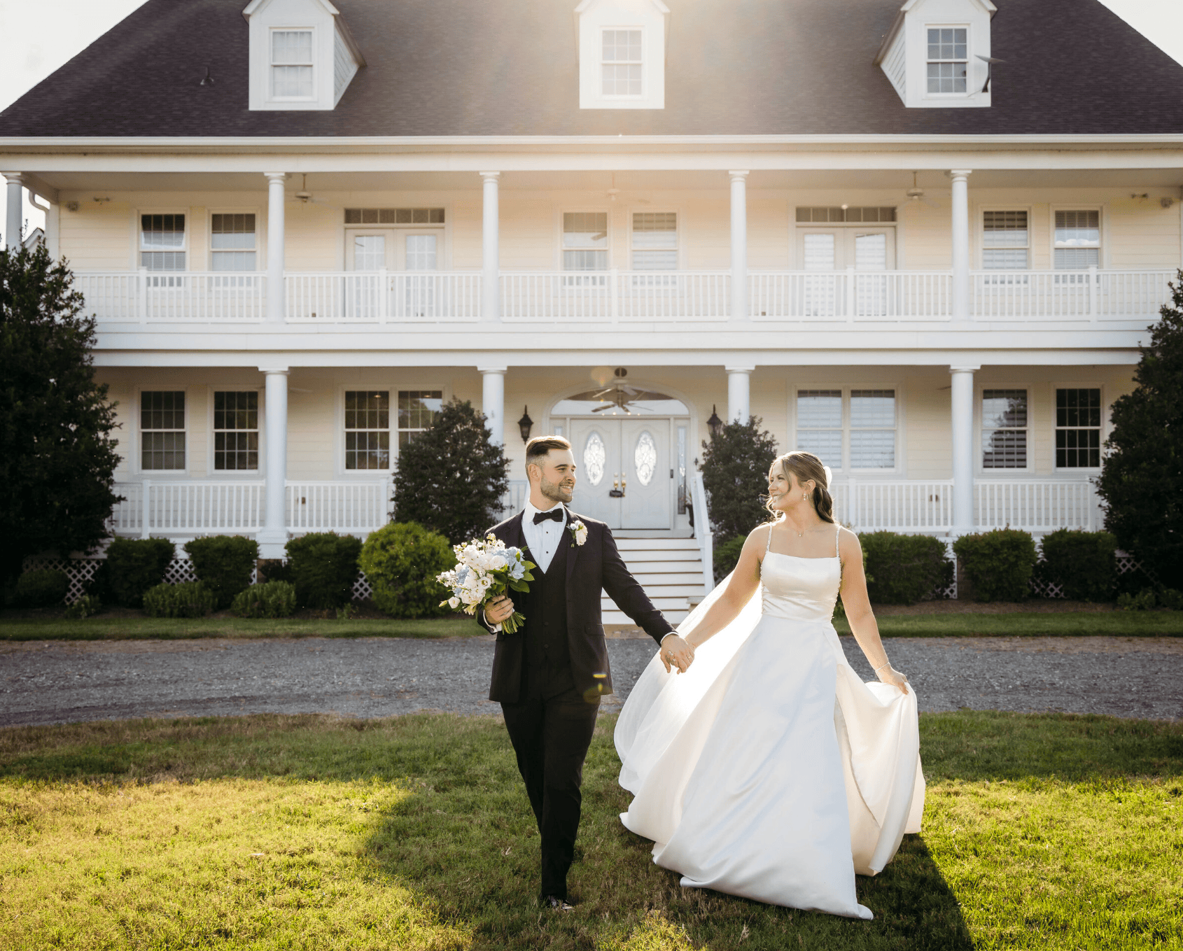 couples holding hands and walking towards camera on their wedding day