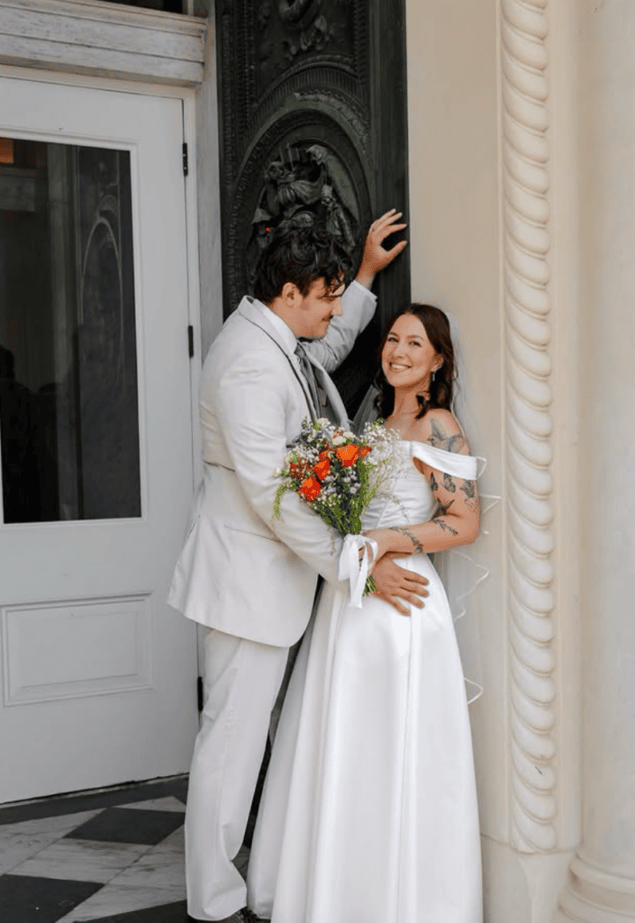 couples leaning up against wall sharing an intimate moment on their wedding day